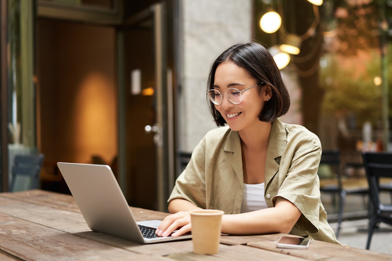 Woman working on computer at cafe